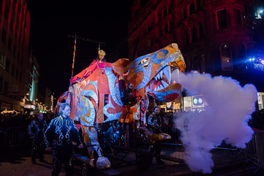 Large animal puppets in a street at night