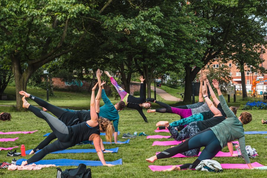 A group of people enjoying a yoga class in the open air.
