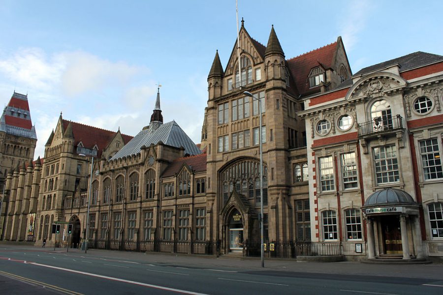 Manchester museum is a long building with lots of windows and doors