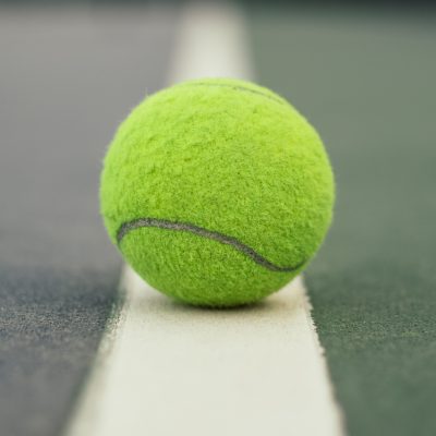 Tennis ball on a tennis court line