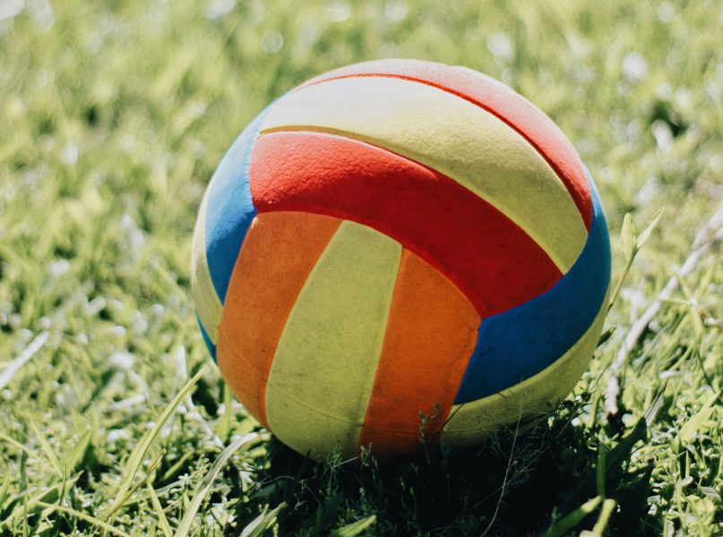 Closeup of a football on grass in the sun
