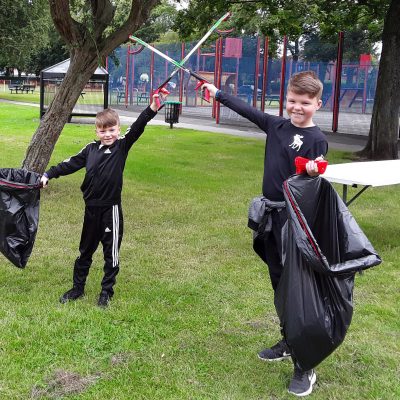 Two children with litter pickers
