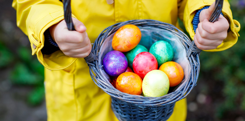 A collection of painted eggs in a basket.