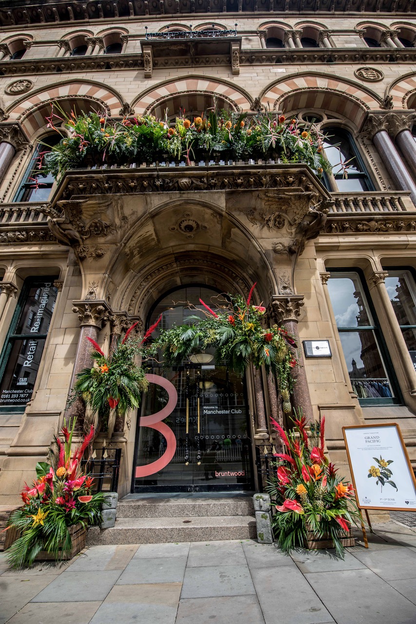 The doorway of the Grand Pacific in Manchester decorated with plants and flowers.