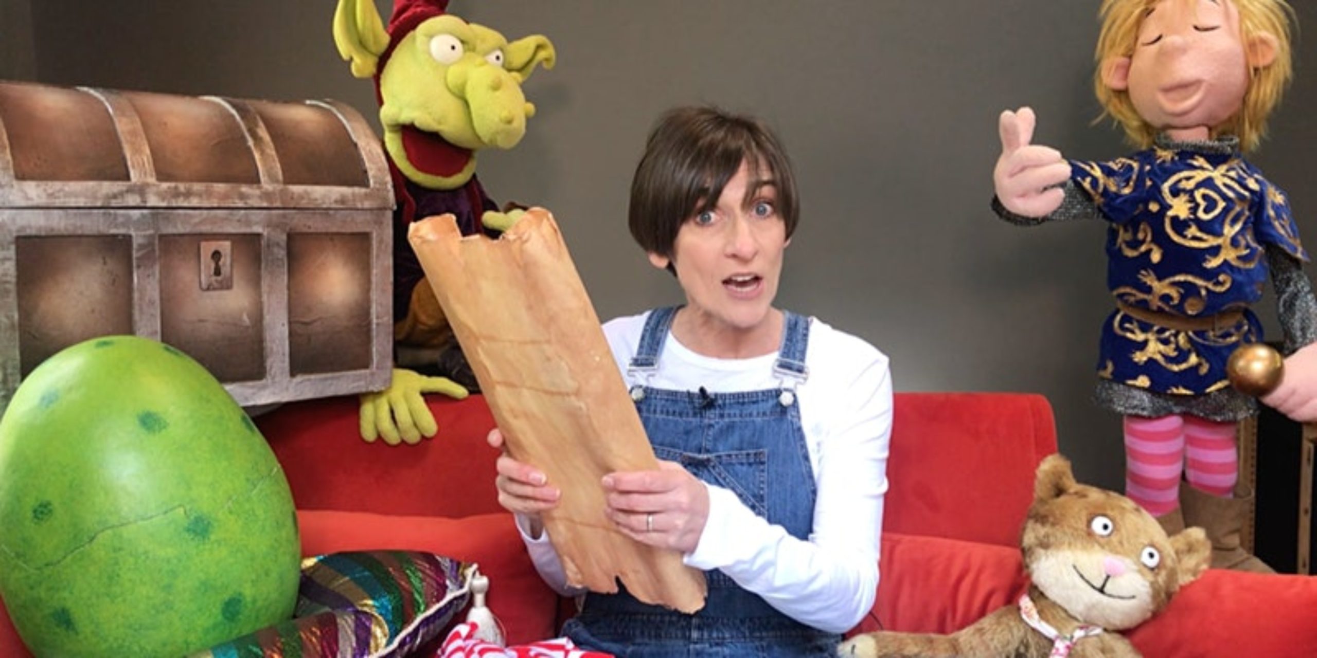 Kristina Stephenson with puppets and scroll