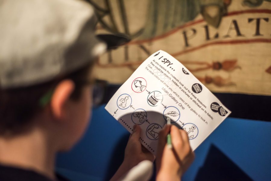 A child holds a ticket to the People's History Museum.