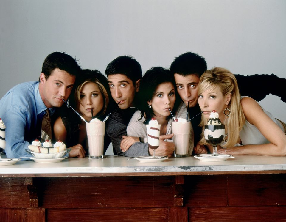 The cast of Friends the TV sitcom sat together drinking milkshakes and eating ice-cream desserts.