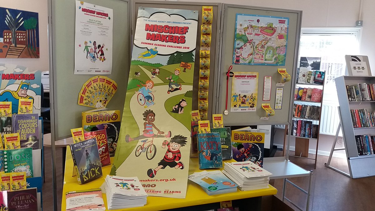 A bright and cheerful display of books and posters at the Summer Reading Challenge by Manchester Libraries.