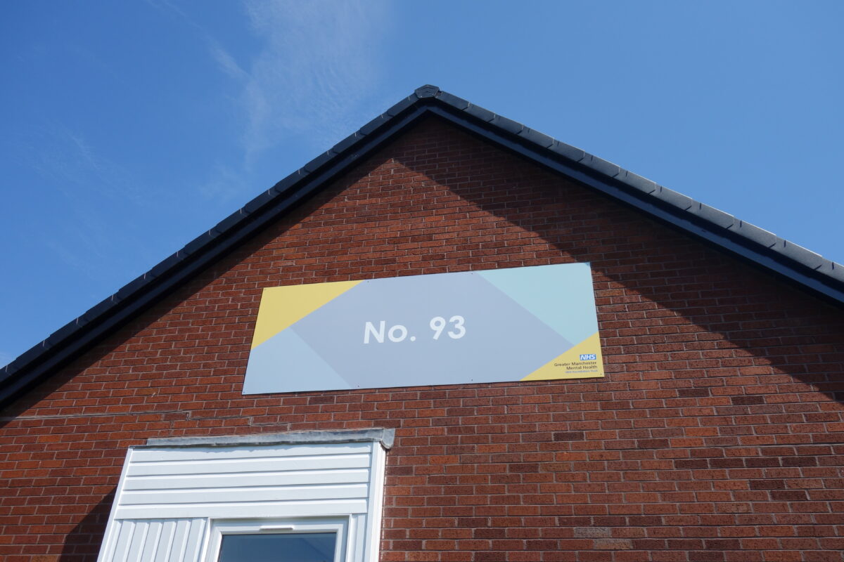 The sign on the outside of the No. 93 Health and Wellbeing Centre in Harpurhey, Manchester.