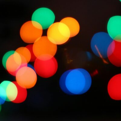A close up picture of orange, yellow, green, blue and red fairy lights.