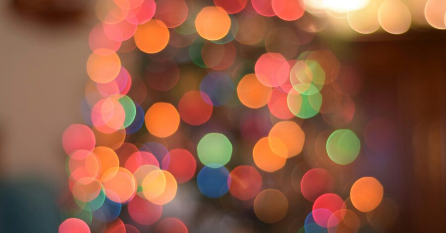 An up close image of the colourful lights on a Christmas tree.