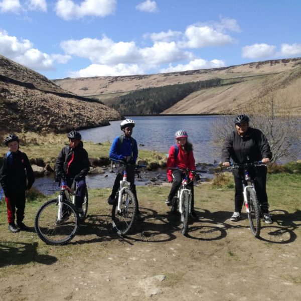 A group of young mountain bikers getting ready to set off.