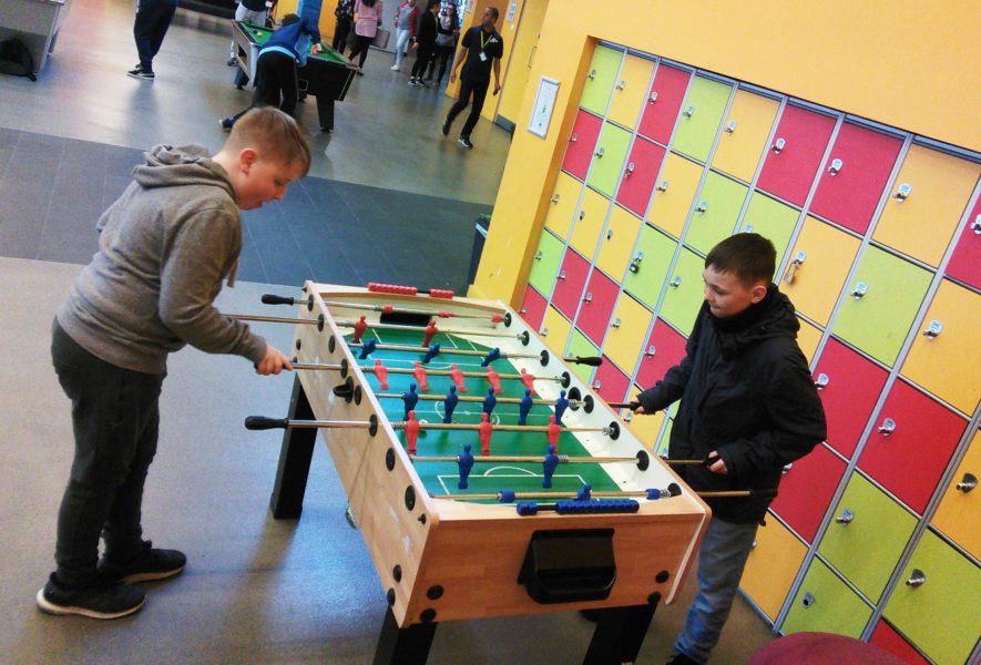 Two young people play table football at Manchester Youth Zone.