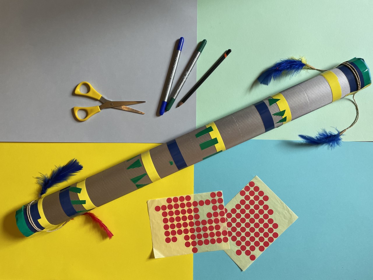 Craft materials used to create the rainstick including scissors, pens, tubes and dots