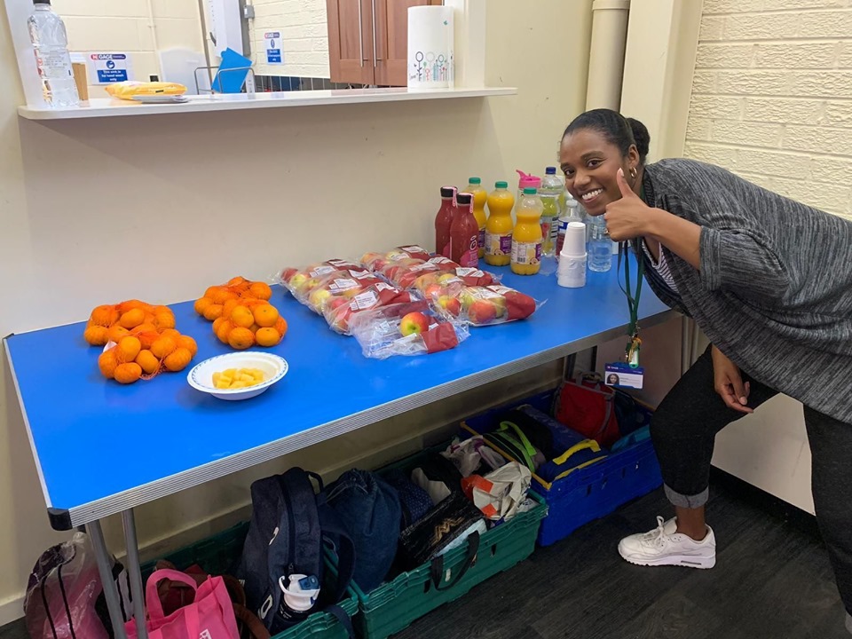 A friendly staff member at Ladybarn Community Hub organises free packed lunches for the young people.