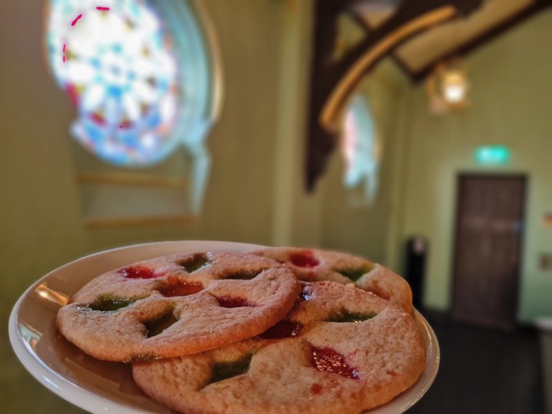 A plate of cookies that are inspired by the design and colour of a stained glass window.