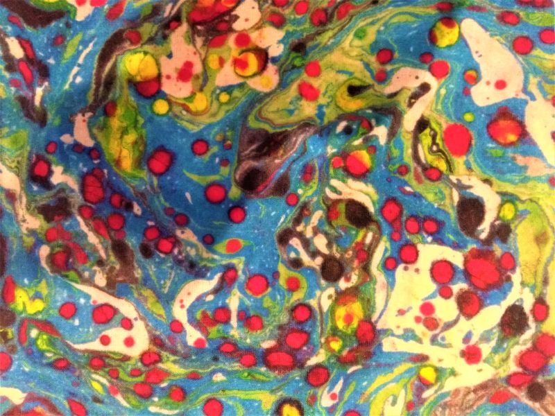 The colourful marble effect created from the swirling of different coloured paint.