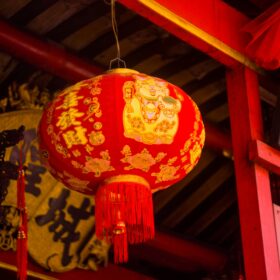 A red and gold Chinese floral paper lantern.