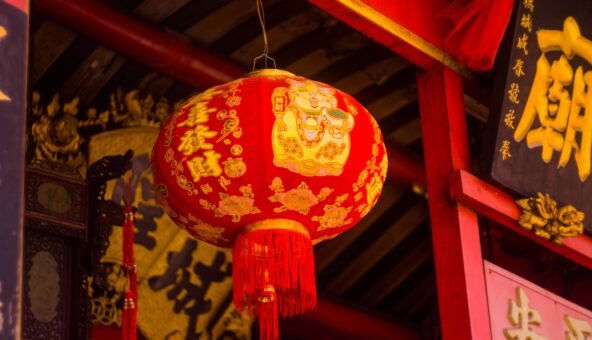 A red and gold Chinese floral paper lantern.