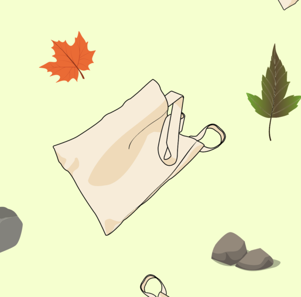 A canvas tote bag blowing in the breeze surrounded by leaves