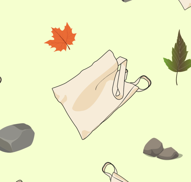 A canvas tote bag flying in the breeze surrounded by leaves.