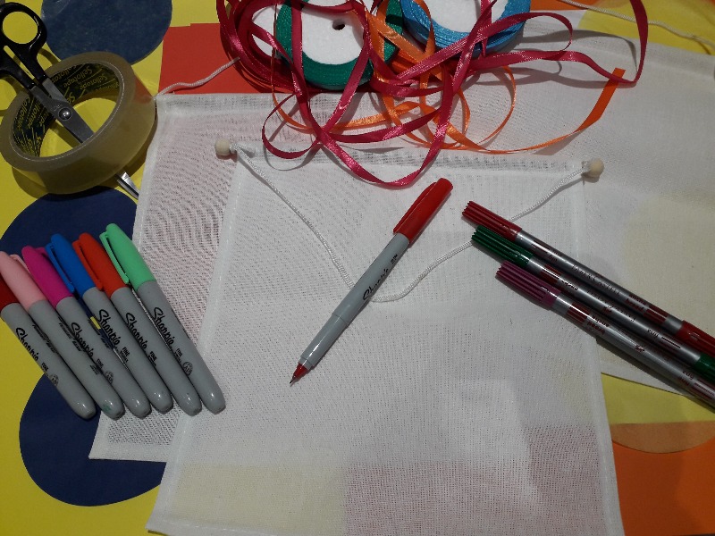 A craft table with paper and coloured pens