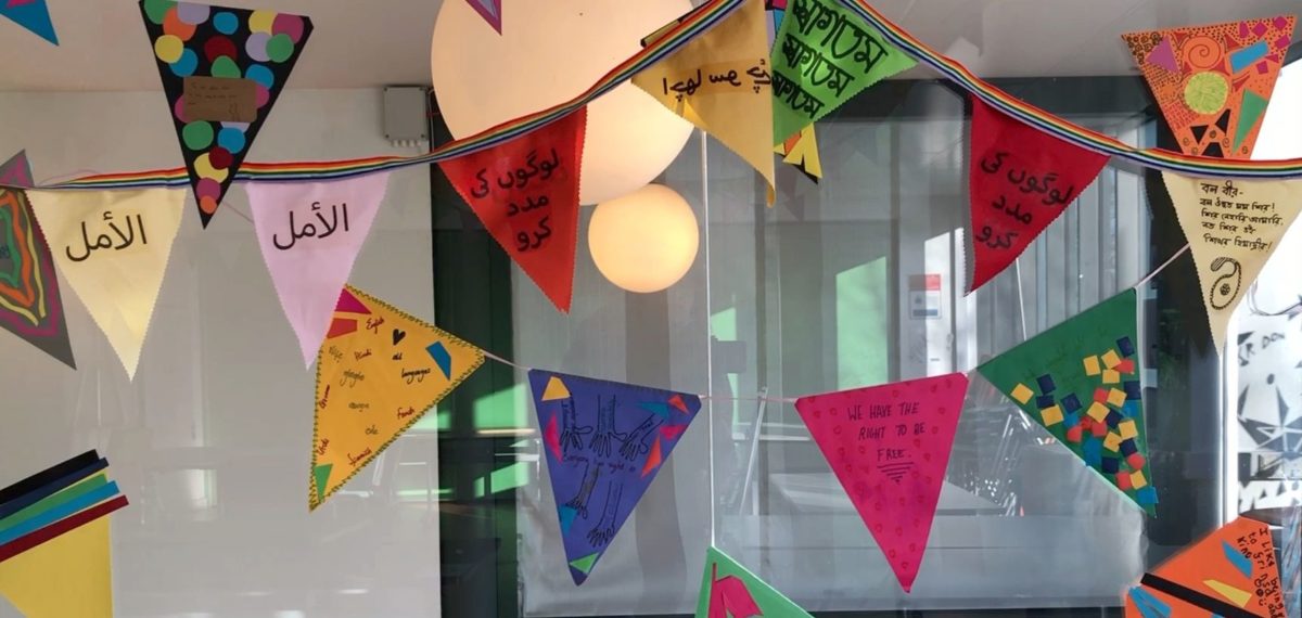 Brightly coloured bunting hangs from the ceiling for International Mother Language Day.