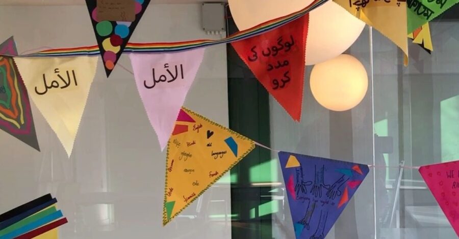 Brightly coloured bunting hangs from the ceiling for International Mother Language Day.