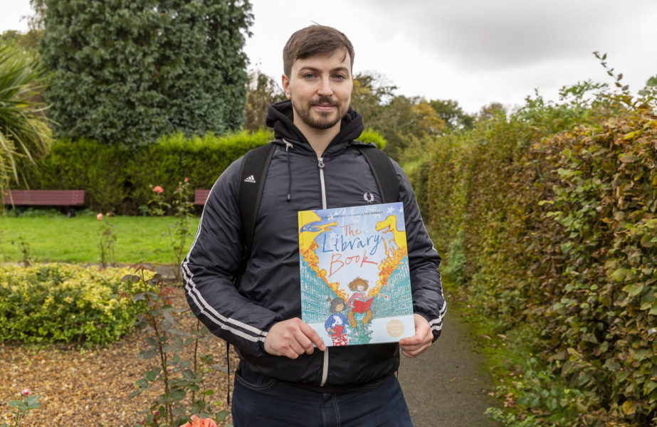 Illustrator Ian Morris holds his book, 'The Library Book'.