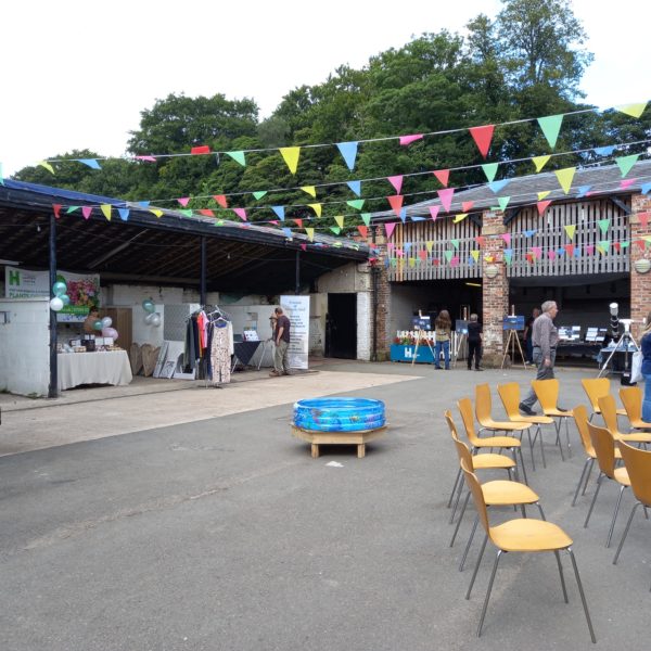 An outdoor market area with colourful bunting