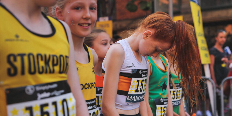 Young runners line up on the start line ready to run