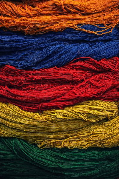 Rows of different coloured thread - orange, blue, red, yellow and green.