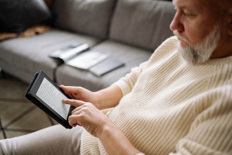 A man reading on his tablet.