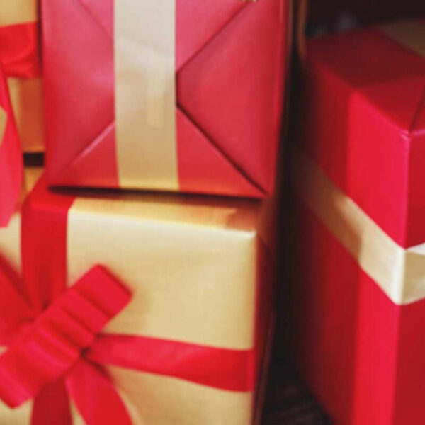 A pile of Christmas presents wrapped in gold and red paper.