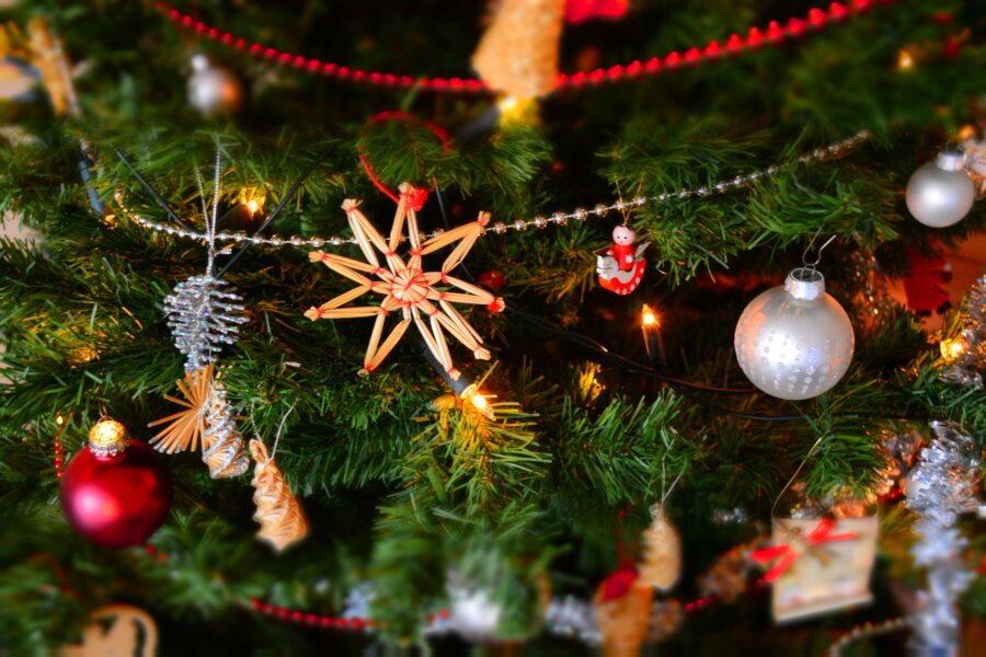A close up of Christmas decorations hanging on a tree
