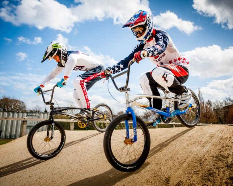 Two People riding BMX on a course.