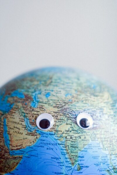 A pair of googly eyes stuck onto a globe.