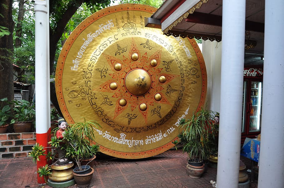 A large Thai temple gong and some plants