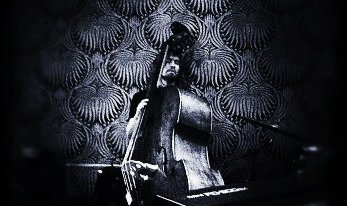 A member of the Grant Russell Quartet plays a double bass.