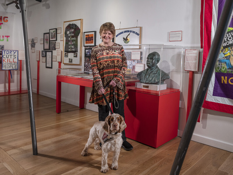 Ruth Malkin, Community Curator in Nothing About Us Without Us exhibition with her dog Flint