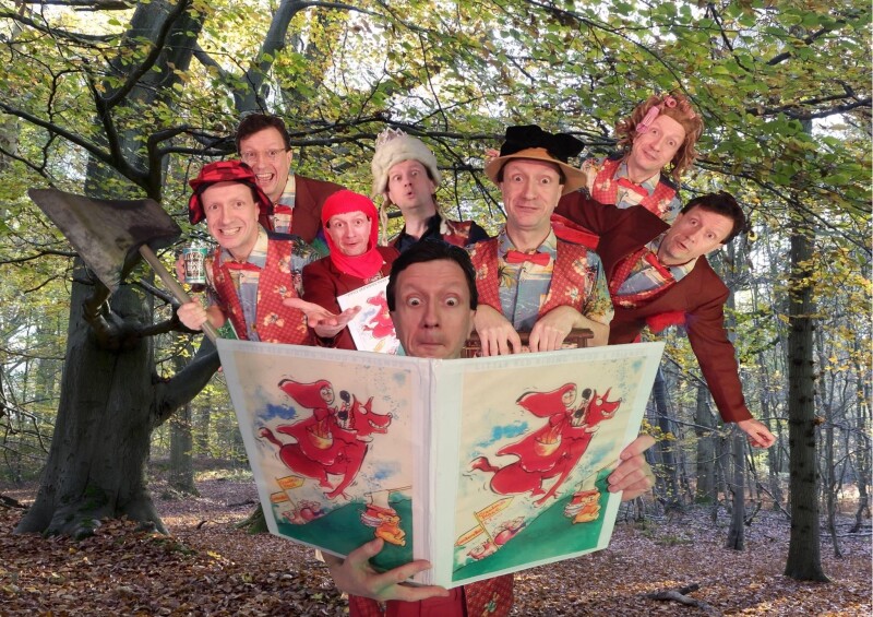 A group of people in a forest reading a large book together.