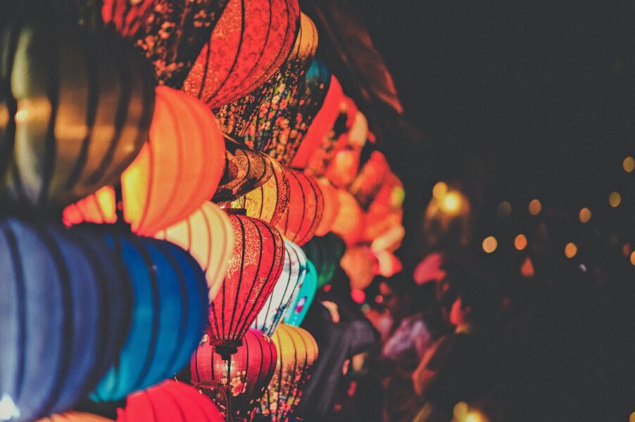 A wall of multi-coloured paper lanterns.
