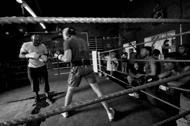 Two people sparring in a boxing ring.