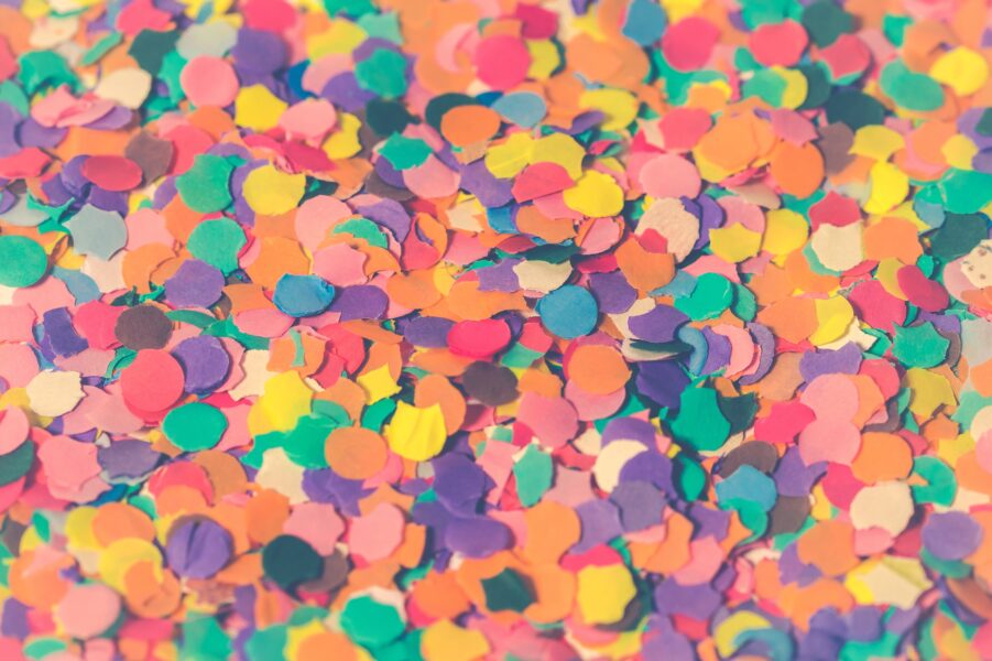 A close up of different coloured paper confetti