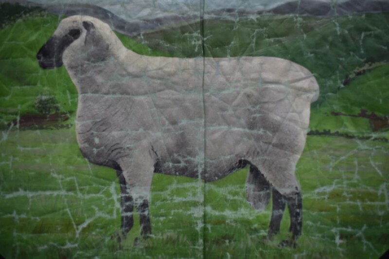 A painting of a sheep in a field