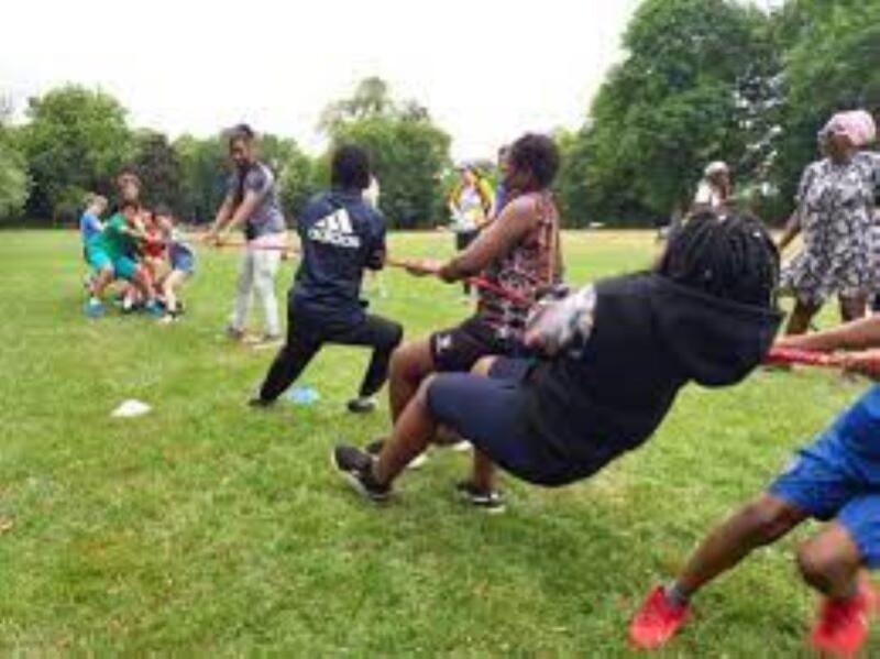 Young people take part in a tug of war.