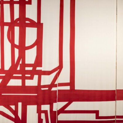 An artwork consisting of a series of red lines and shapes painted onto a white canvas.