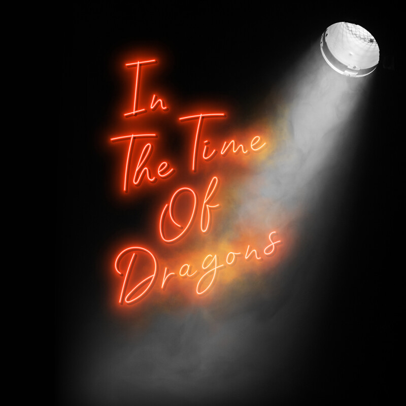 A spotlight shines on a red neon sign that reads 'In The Time Of Dragons'.