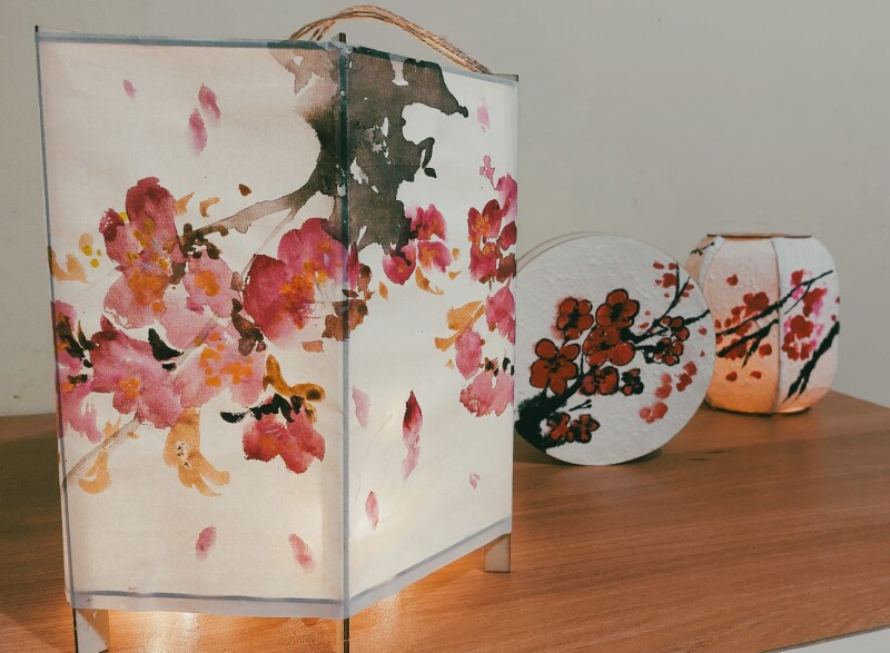 White paper Chinese lanterns handpainted with flowers.