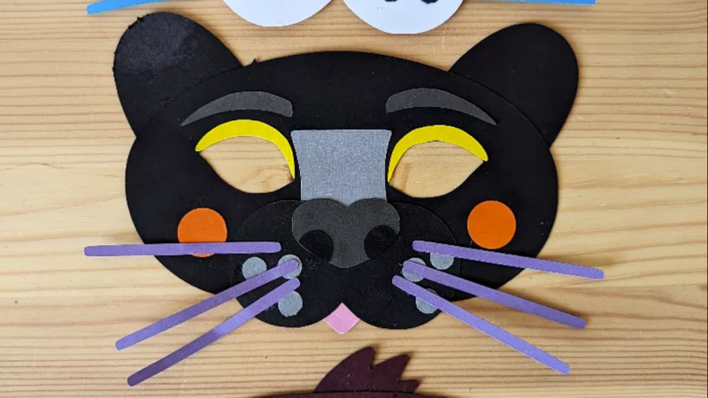 A homemade black panther mask with purple straw whiskers.